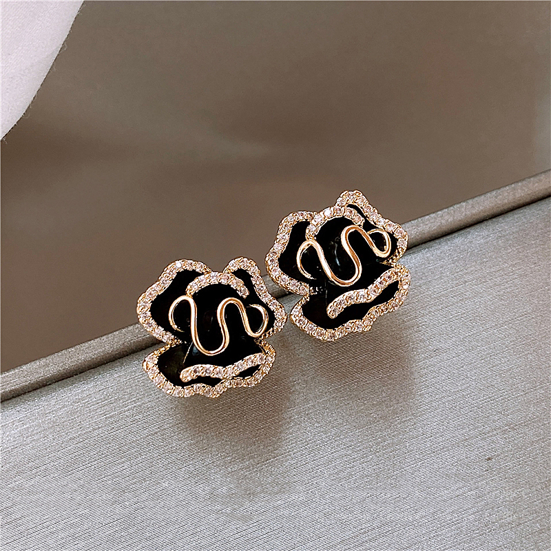 Pendientes de loto negros elegantes con un acento dorado.