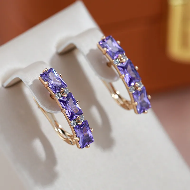 Fascinantes pendientes dorados con brillantes cristales violetas