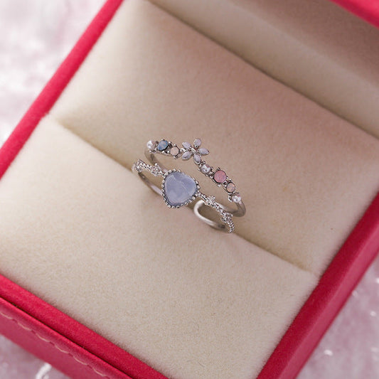 Anillo de plata ajustable elegante con piedra azul brillante y piedras de circonio