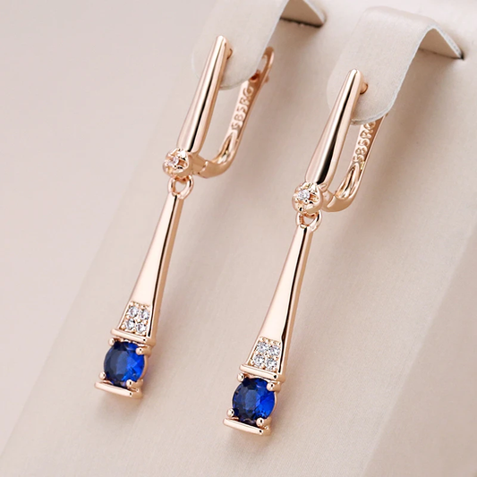 Pendientes elegantes dorados con colgantes de cristal azul
